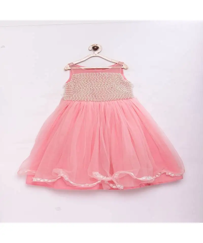 Peach fashionable girls net with pearls on front , flared party gown
