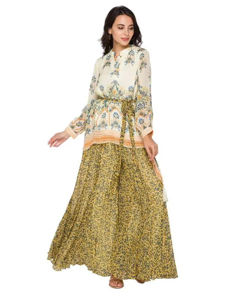 Yellow printed asymetrical top paired with sharara pants and belt