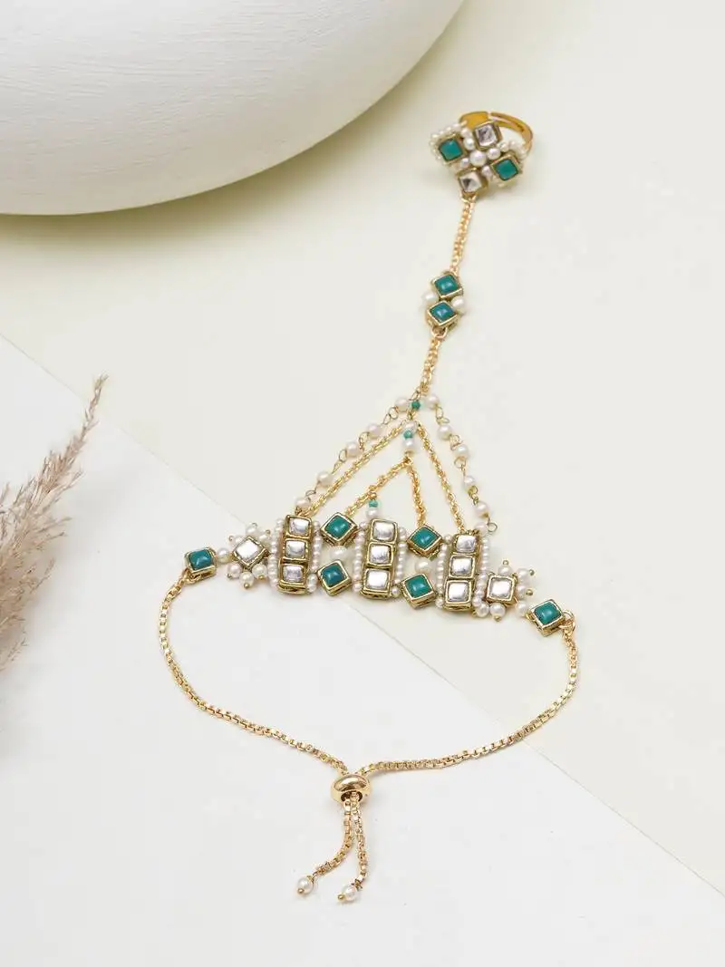 Gold-plated haathphool with emerald accents