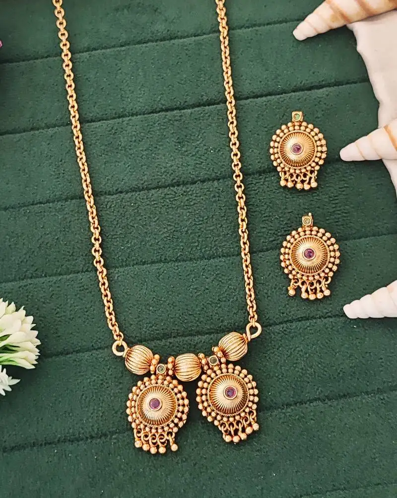 Elegant gold-plated pendant and earring set with red and green stones