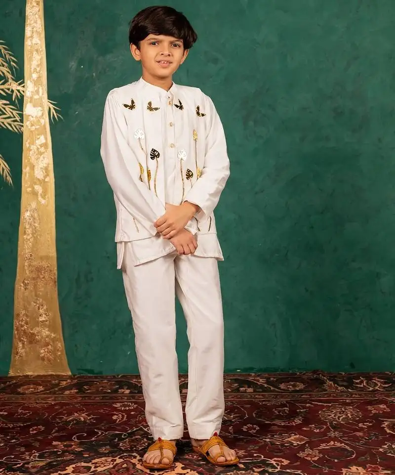 Boys white silk kurta and pants with handwork acrylic bundi jacket