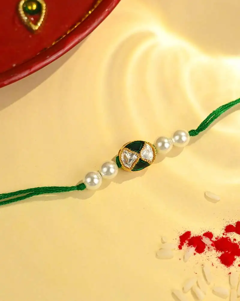 Green thread rakhi with dual stone oval charm and pearl beads