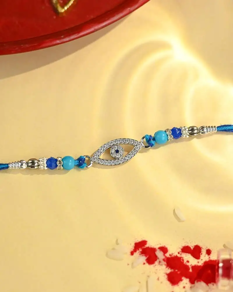 Blue thread evil eye rakhi with sparkling stones and beads