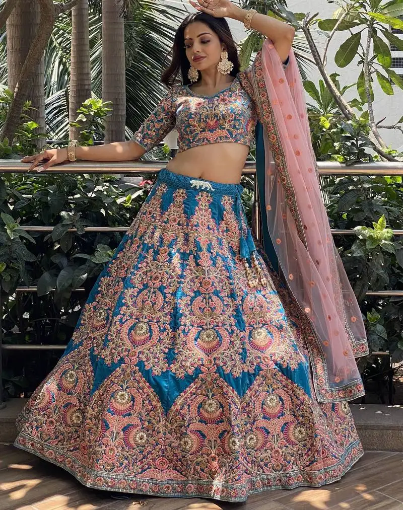 Adorable blue embroidered velvet wedding lehenga choli with dupatta