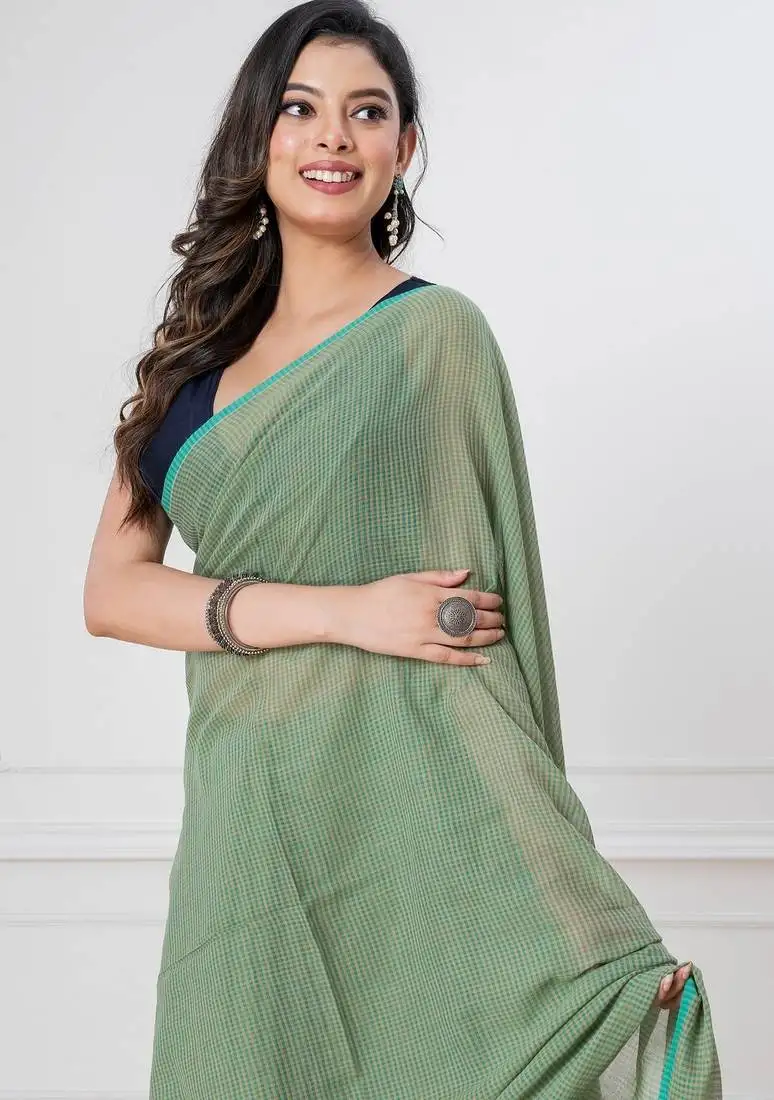 Light green handloom mark mul cotton all over small checks with tassels saree