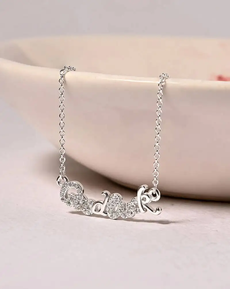 Engraved silver pendant necklace with 'good luck' inscription and sleek design