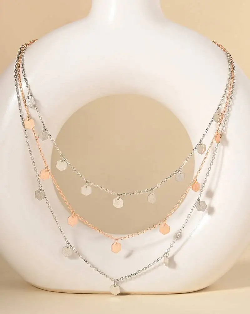 Triple layered heart charm necklace with gold chain accent and romantic touch