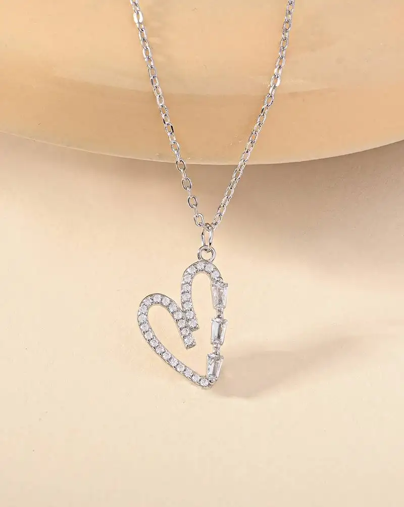 Heart-shaped cz silver pendant necklace with trailing stones and romantic vibe