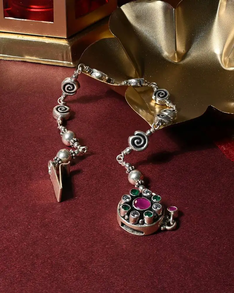 Gem accents intricate silver anklet