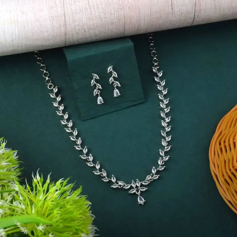 Silver color american diamond necklace set featuring crystal droplet design