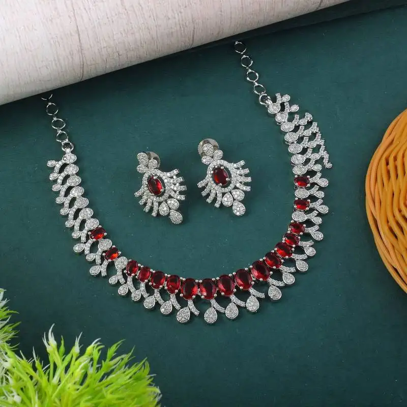 Red color american diamond necklace set with gold-toned leaf accents