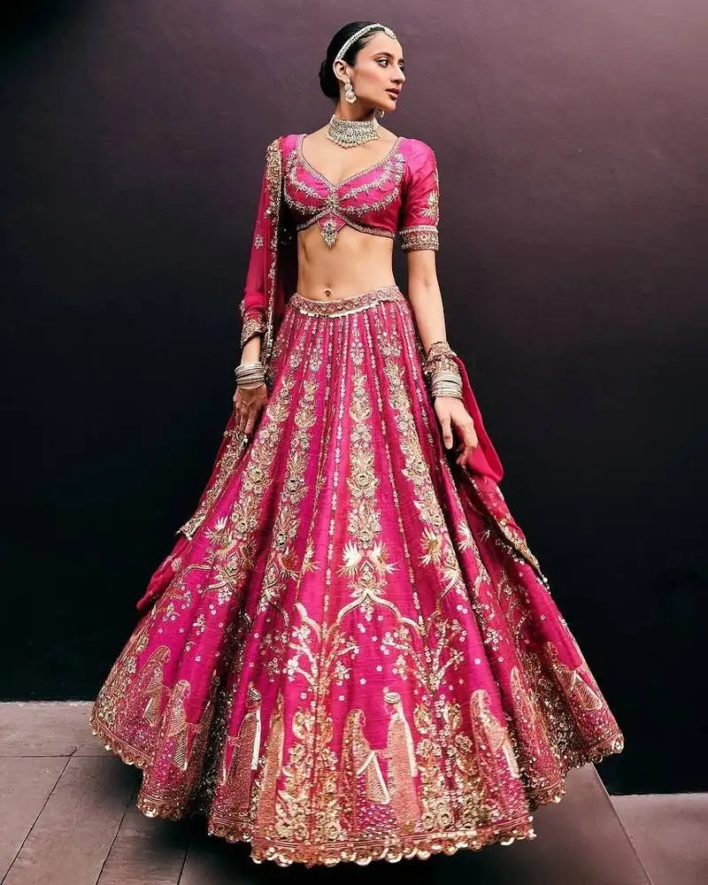 Rani pink wedding lehenga with embroidery, heavy flair & unstitched blouse