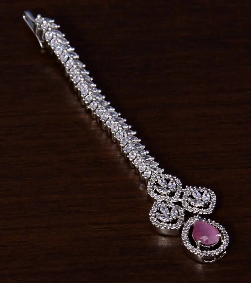 Rhodium plated baby pink and ad stone embellished designer tikka 217mts120