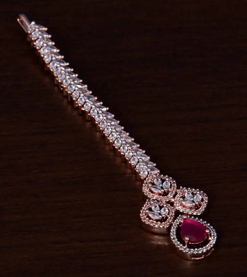 Rose gold plated ruby and ad stone embellished designer tikka 217mts121