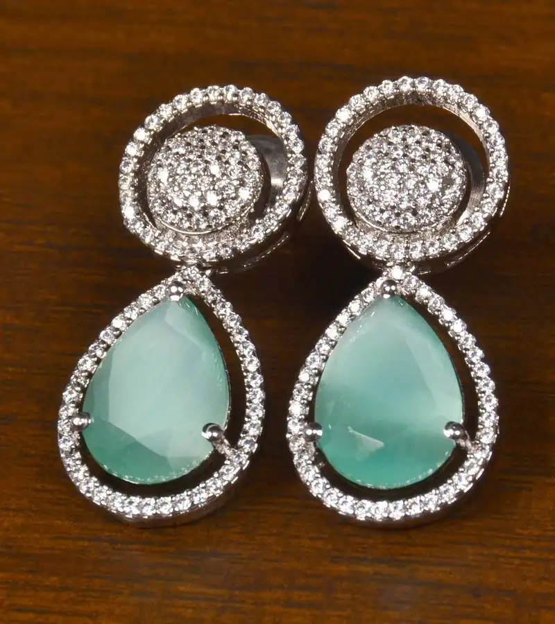 Rhodium plated american diamond and mint stone embellished earrings 216ed398