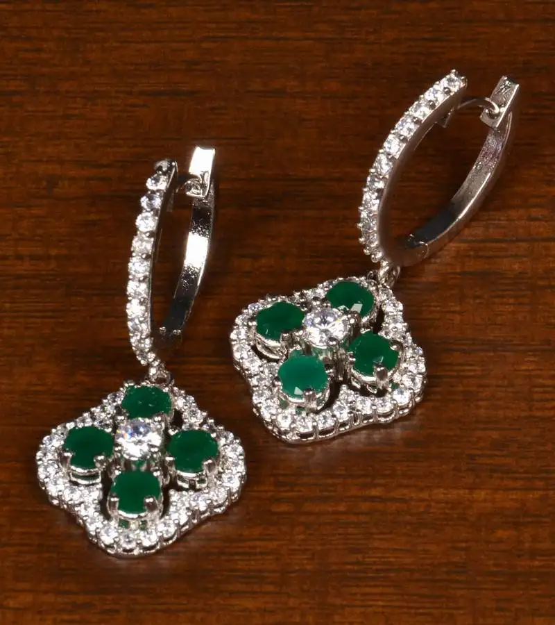 Rhodium plated american diamond and emerald embellished danglers 216ed394