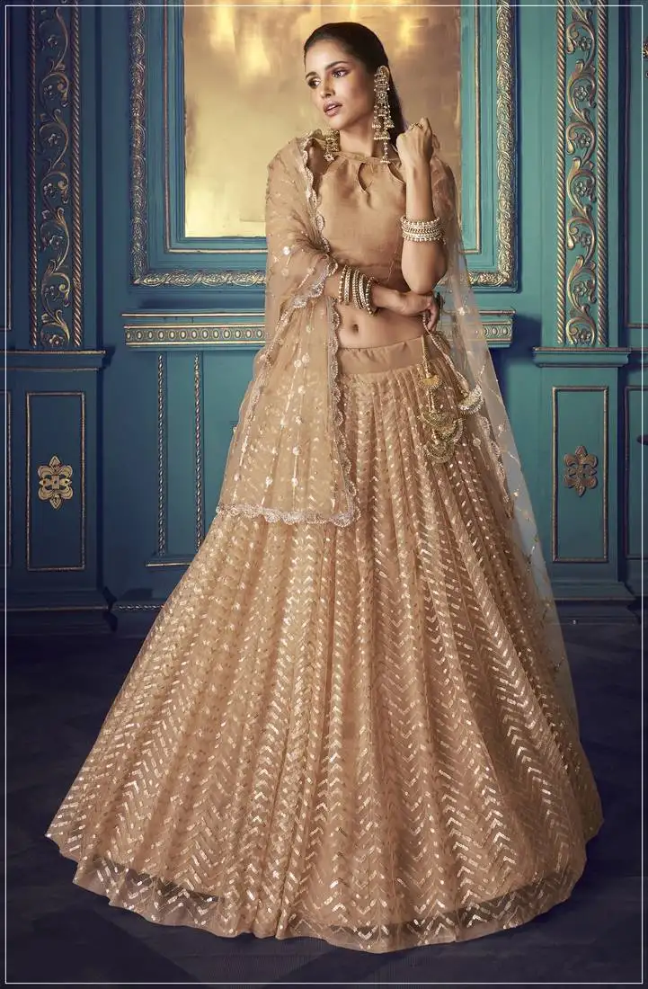 Glamorous beige colored sequins embroidered net fabric lehenga choli for wedding