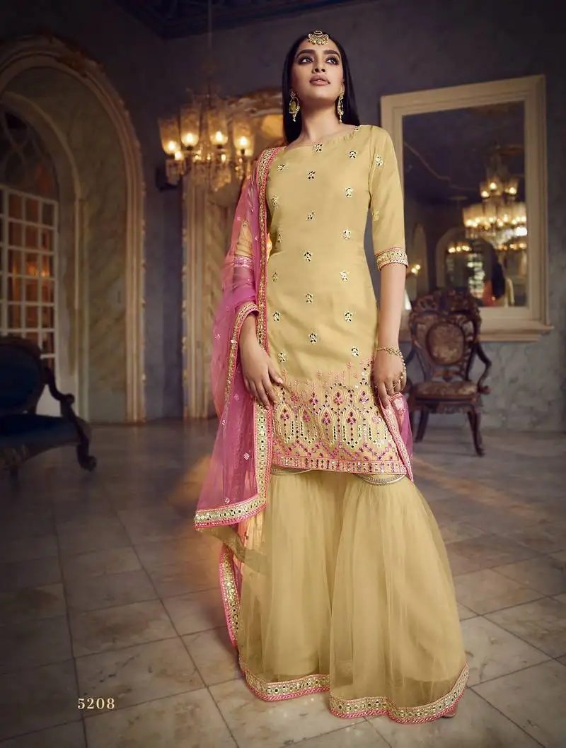 Beige colored thread embroidered with foil mirror work organza gharara type sharara suit for festive semi stitched